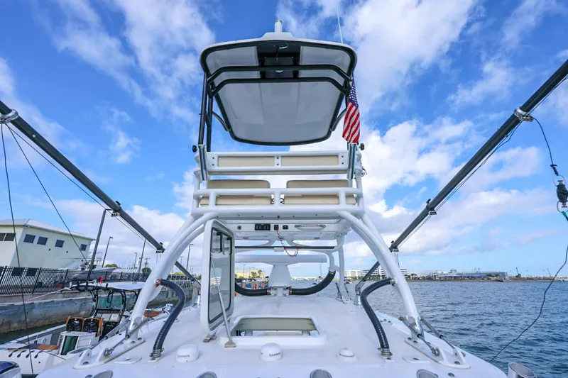 Slide: The Image of 2017 Everglades 355 Center Console boat docked, featuring a tower and outriggers. - 88