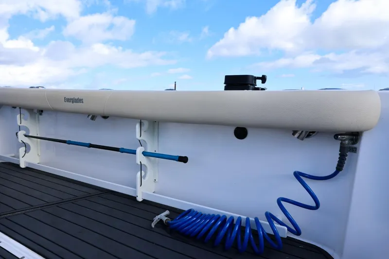 Slide: The Image of 2017 Everglades 355 Center Console boat deck with rod holders and coiled hose. - 96