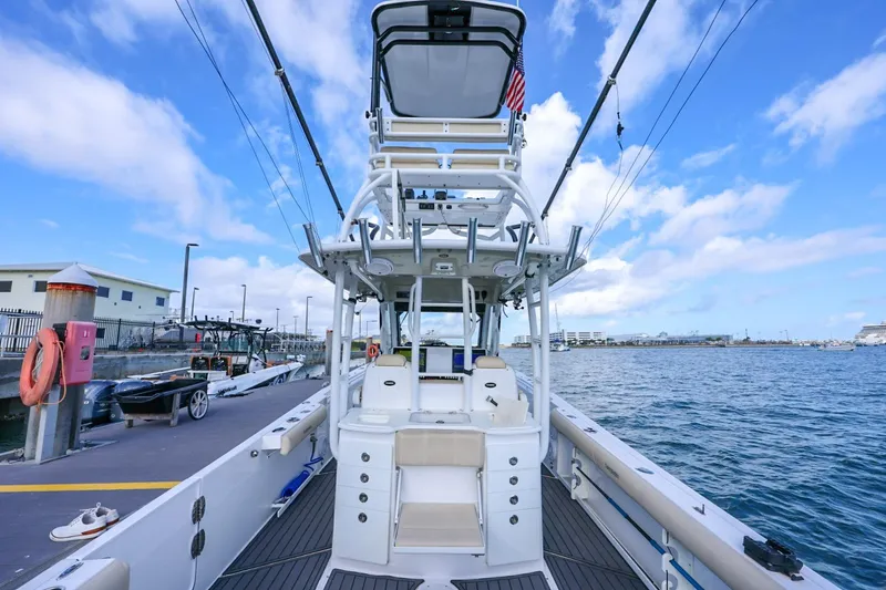 Slide: The Image of 2017 Everglades 355 Center Console boat docked, featuring spacious deck and fishing equipment. - 98