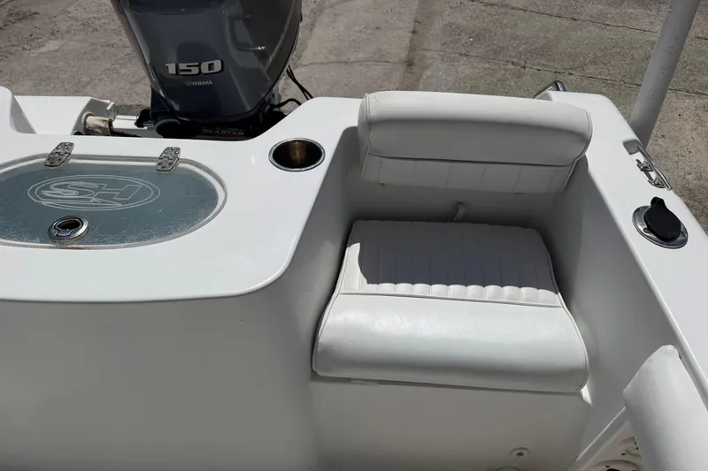 Slide: The Image of 2017 Sea Hunt Triton 210 boat interior with Yamaha 150 engine and seating area. - 15