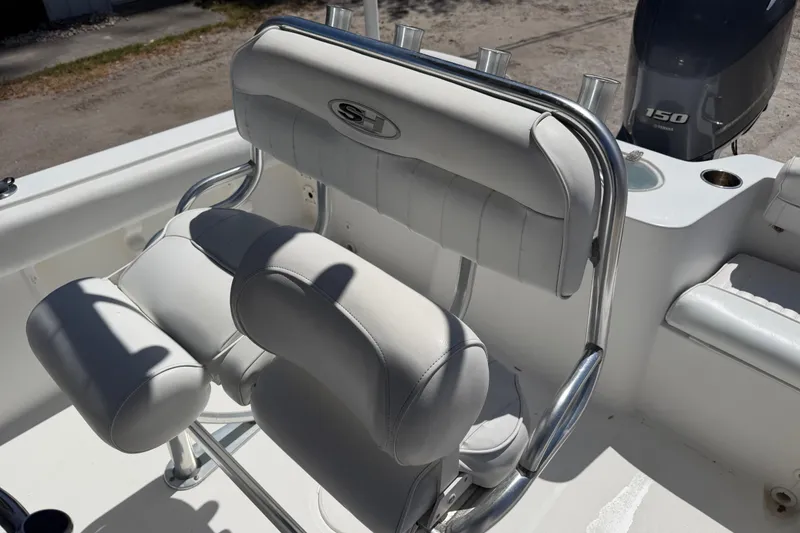 Slide: The Image of 2017 Sea Hunt Triton 210 boat seating with Yamaha 150 engine in background. - 16