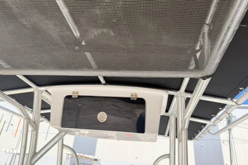 Slide: The Image of 2017 Sea Hunt Triton 210 boat canopy and storage compartment detail. - 20
