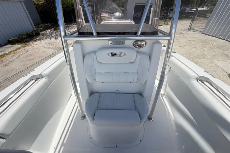 Slide: The Image of 2017 Sea Hunt Triton 210 boat interior with white seating and stainless steel frame. - 21