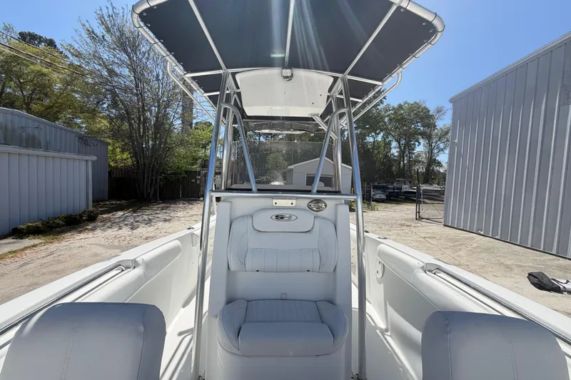 Slide: The Image of 2017 Sea Hunt Triton 210 boat with T-top, white seating, and outdoor storage setting. - 22