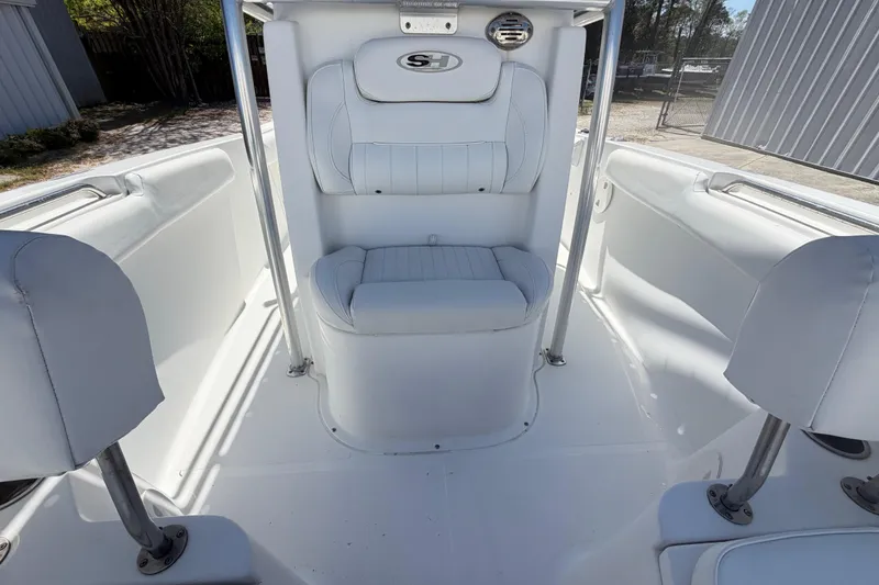 Slide: The Image of 2017 Sea Hunt Triton 210 boat interior with white seating and sleek design. - 23