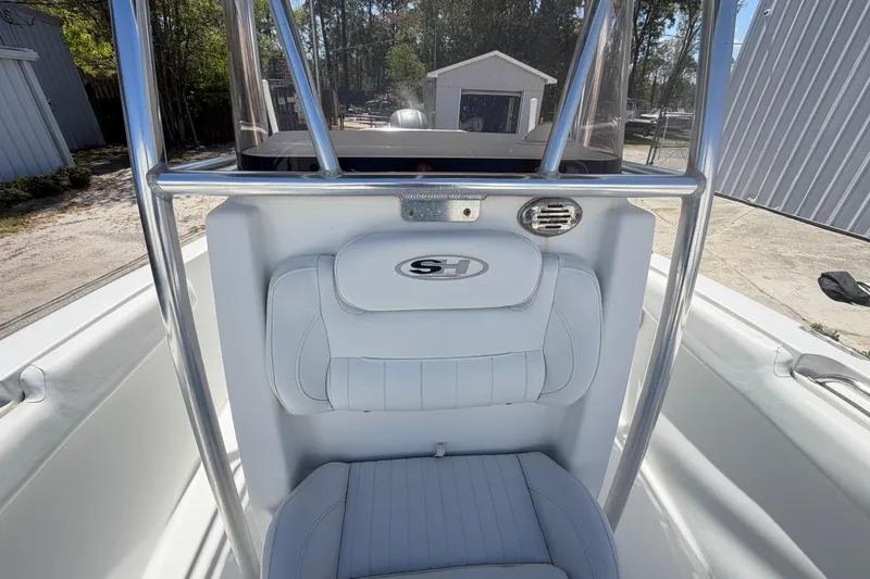 Slide: The Image of 2017 Sea Hunt Triton 210 boat interior with white seating and stainless steel frame. - 24