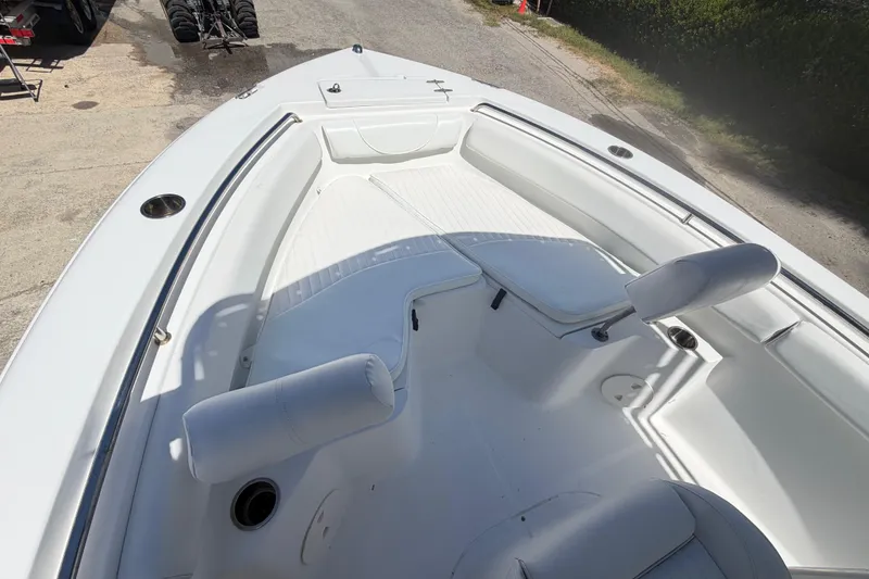 Slide: The Image of 2017 Sea Hunt Triton 210 boat interior with white seating and spacious deck. - 26