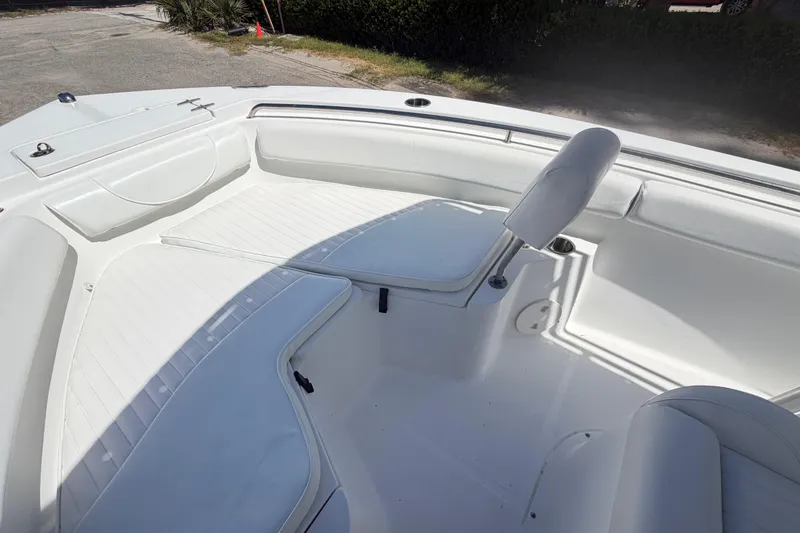 Slide: The Image of 2017 Sea Hunt Triton 210 boat interior with white seating and storage compartments. - 27