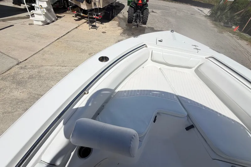 Slide: The Image of 2017 Sea Hunt Triton 210 boat interior with white seating and deck. - 28