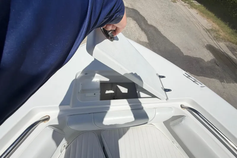 Slide: The Image of Person opening hatch on 2017 Sea Hunt Triton 210 boat deck. - 29