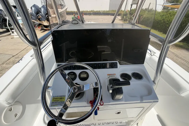 Slide: The Image of 2017 Sea Hunt Triton 210 boat console with steering wheel and controls. - 33