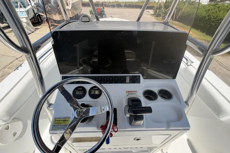 Slide: The Image of 2017 Sea Hunt Triton 210 boat console with steering wheel and controls. - 37