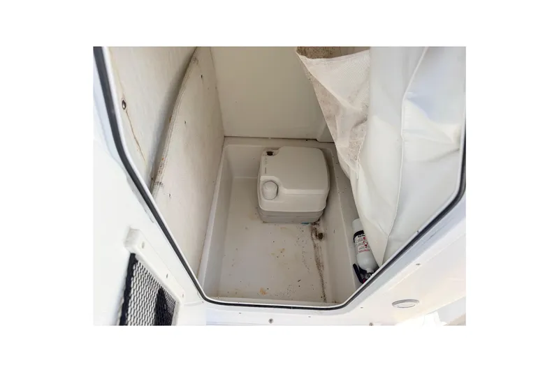 Slide: The Image of 2017 Sea Hunt Triton 210 boat interior with portable toilet and storage space. - 38