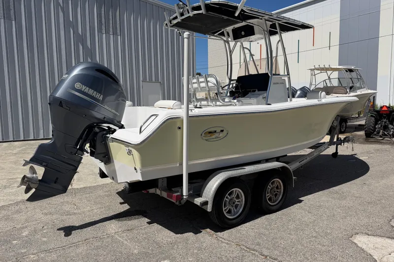 Slide: The Image of 2017 Sea Hunt Triton 210 boat with Yamaha outboard motor on a trailer. - 7