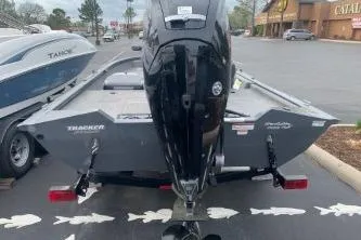 Slide: The Image of 2016 Tracker Pro Team 175 TF boat with outboard motor in parking lot. - 2