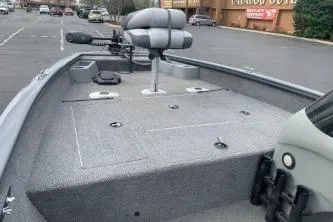 Slide: The Image of 2016 Tracker Pro Team 175 TF fishing boat with seating and storage in a parking lot. - 5