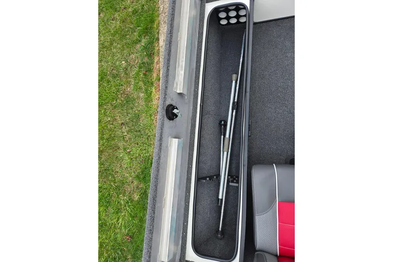 Slide: The Image of 2018 Ranger RT188C boat storage compartment with fishing rod holders and seating. - 16