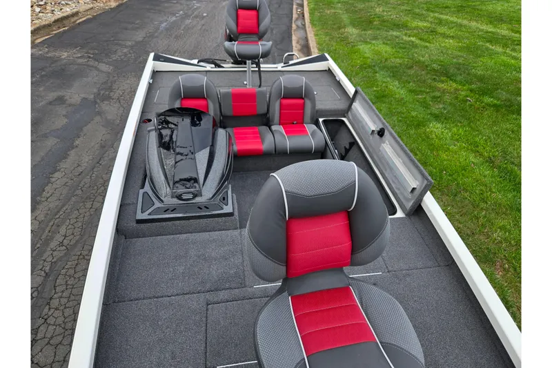 Slide: The Image of 2018 Ranger RT188C boat interior with red and gray seating, open storage compartments. - 19