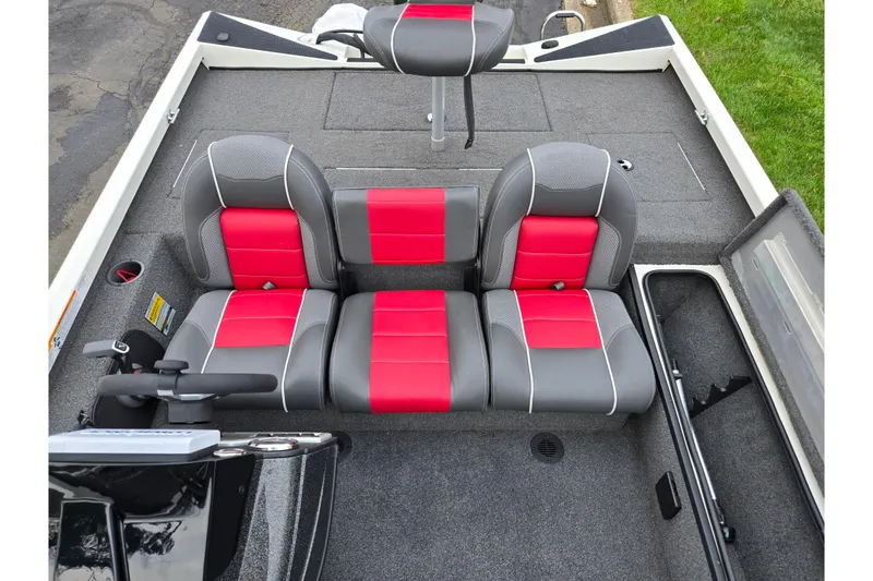 Slide: The Image of 2018 Ranger RT188C boat interior with red and gray seating, steering console, and storage compartments. - 20