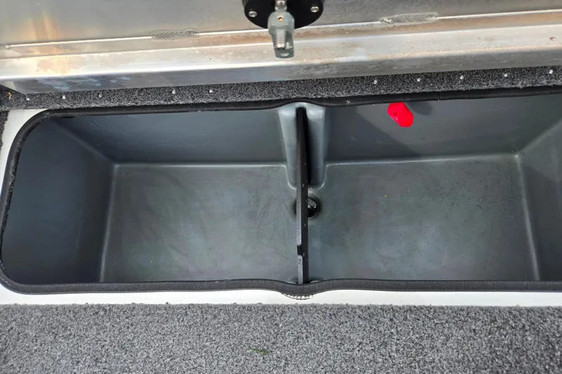Slide: The Image of 2018 Ranger RT188C boat storage compartment with gray interior and red latch. - 23