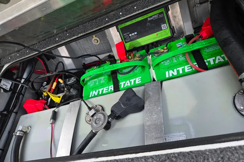 Slide: The Image of 2018 Ranger RT188C boat battery compartment with Interstate batteries and RealPRO charger. - 25
