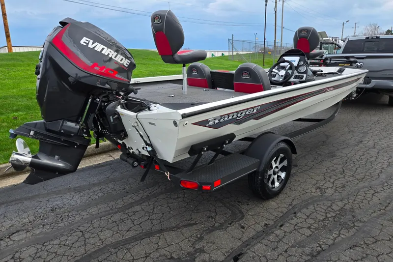 Slide: The Image of 2018 Ranger RT188C boat with Evinrude motor on trailer, parked on asphalt road. - 3