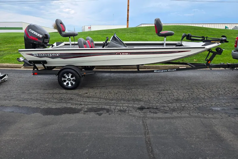 Slide: The Image of 2018 Ranger RT188C fishing boat on trailer with Evinrude motor, parked on asphalt. - 4