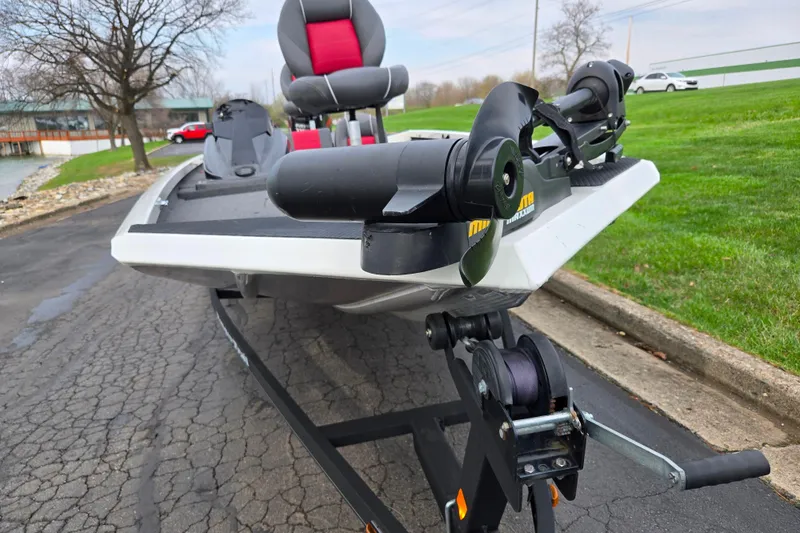 Slide: The Image of 2018 Ranger RT188C boat on trailer, featuring a trolling motor and red-accented seats. - 6