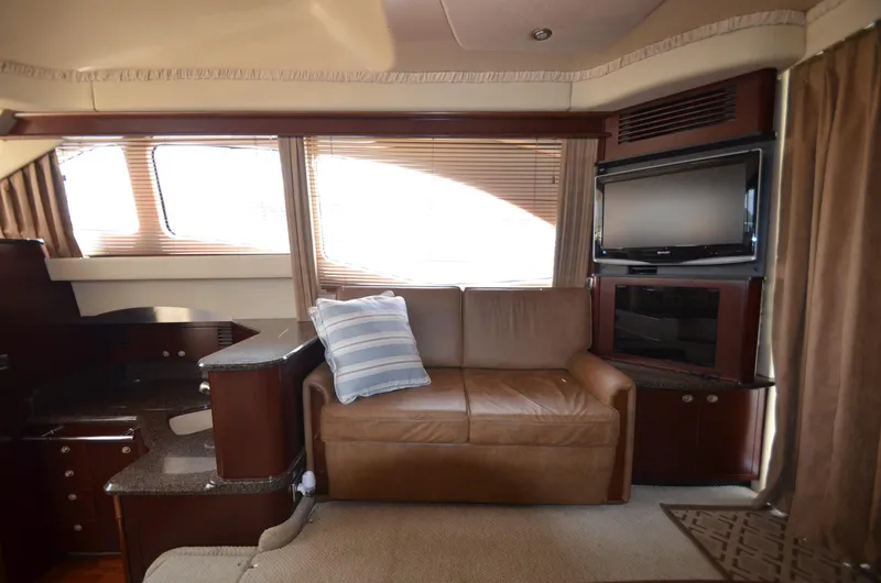 Slide: The Image of Interior of 2005 Sea Ray 420 Sedan Bridge with sofa and TV. - 11