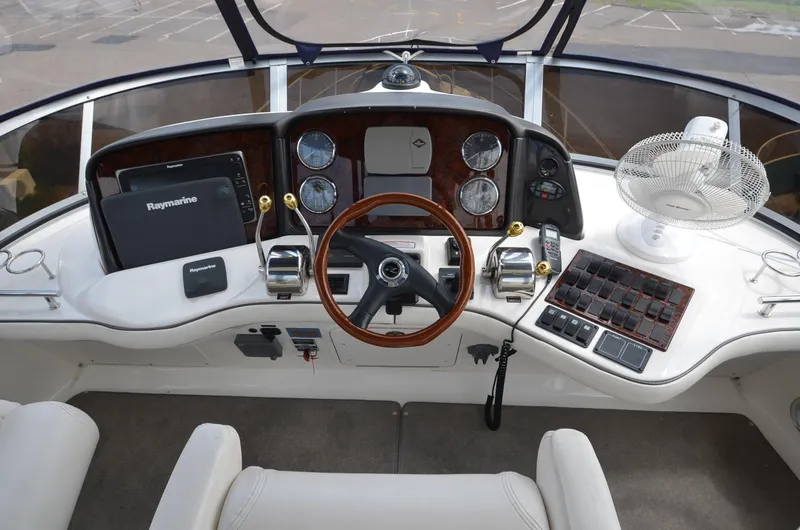 Slide: The Image of 2005 Sea Ray 420 Sedan Bridge cockpit with controls and instruments. - 18