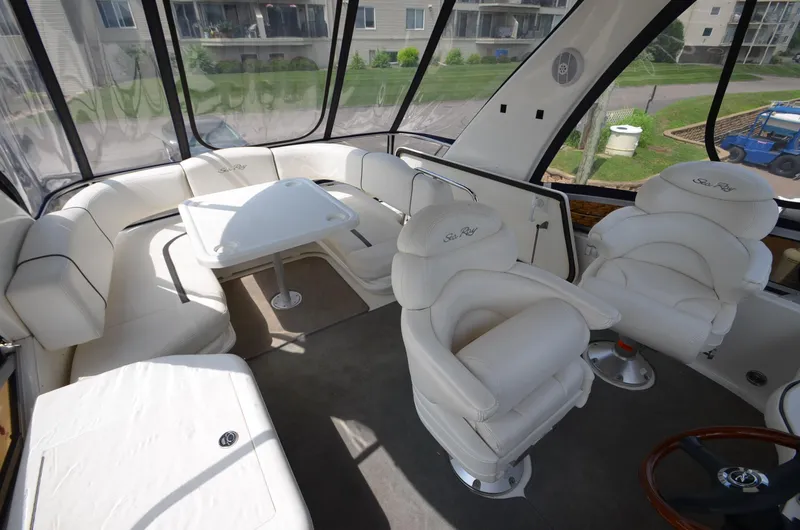 Slide: The Image of Interior of a 2005 Sea Ray 420 Sedan Bridge yacht with white leather seating. - 19