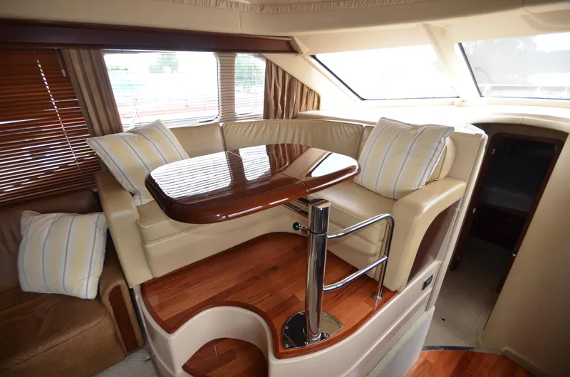 Slide: The Image of Interior of 2005 Sea Ray 420 Sedan Bridge with elegant seating area. - 7