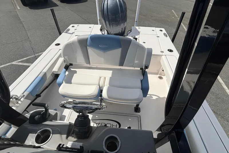 Slide: The Image of 2025 Robalo 246 Cayman boat interior with seating and steering wheel. - 10