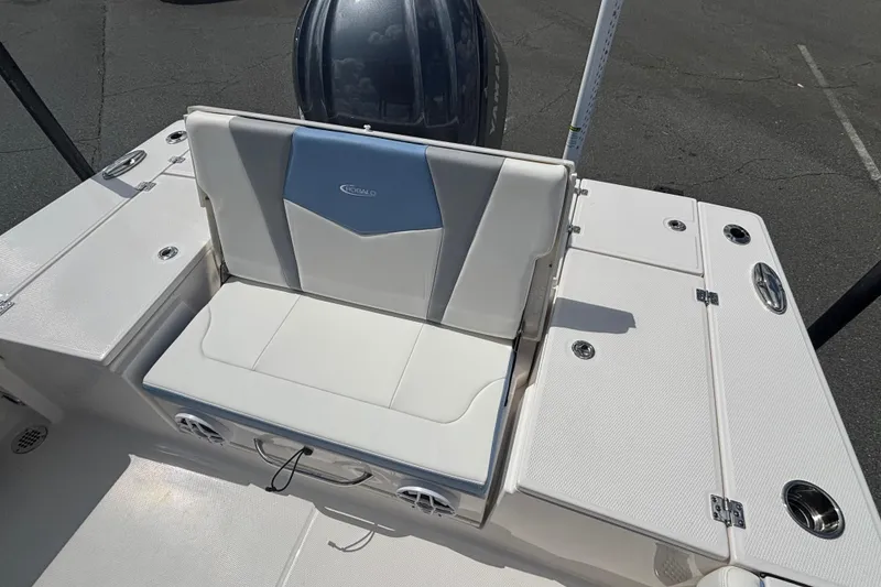 Slide: The Image of 2025 Robalo 246 Cayman boat seating area with storage compartments and sleek design. - 11