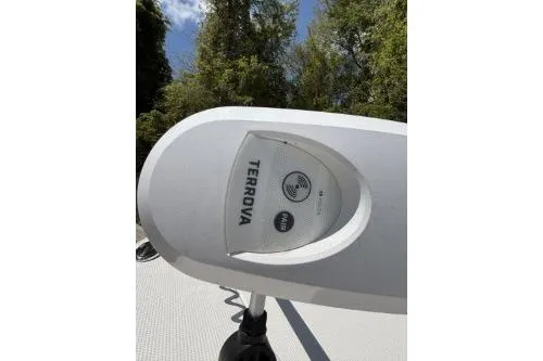 Slide: The Image of 2025 Robalo 246 Cayman boat with Terrova trolling motor, surrounded by trees. - 6