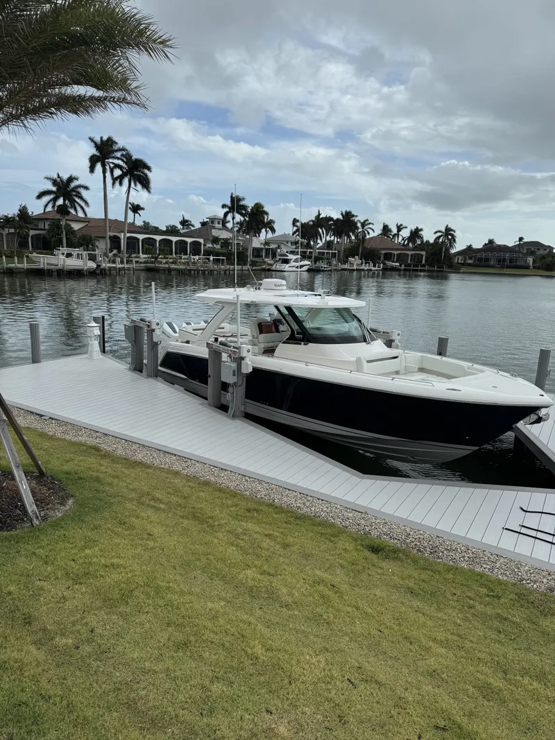 The Image of 2024 Tiara Yachts 38 LS docked with palm trees in background. - 0