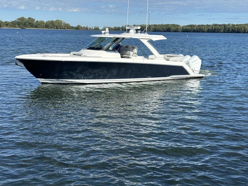 Slide: The Image of 2024 Tiara Yachts 38 LS cruising on calm waters. - 2