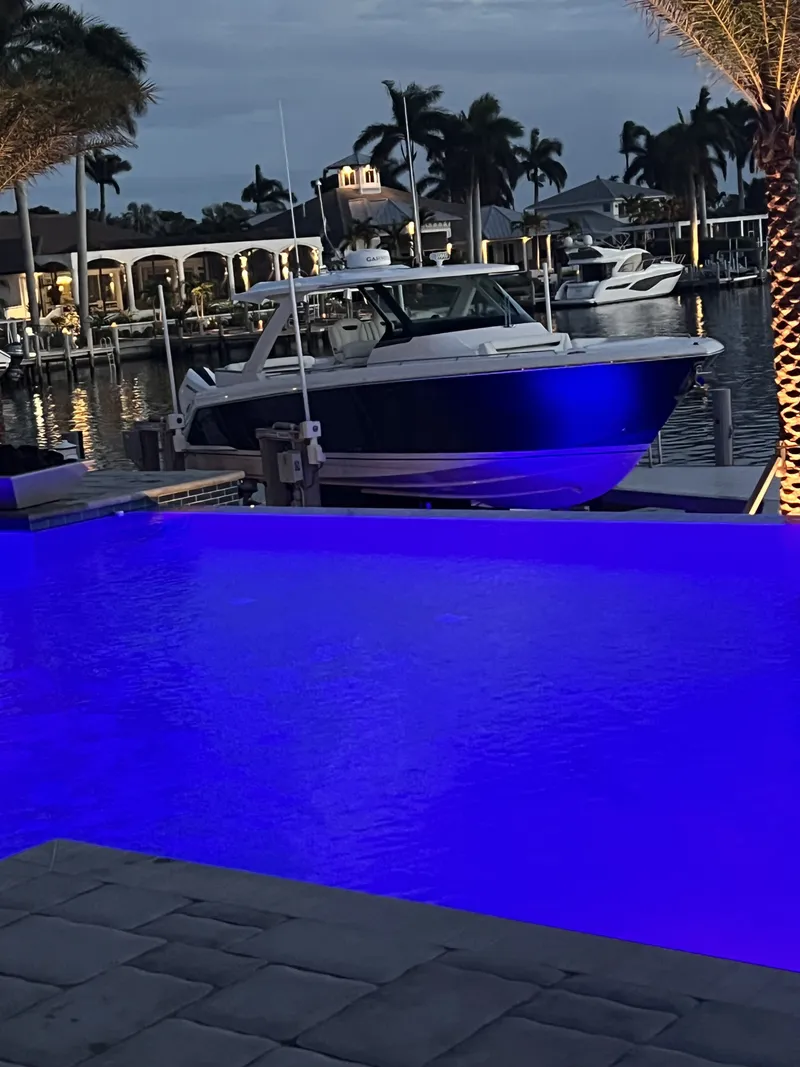 Slide: The Image of 2024 Tiara Yachts 38 LS docked with night lighting. - 25