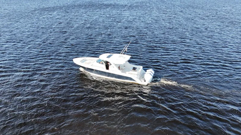 Slide: The Image of 2024 Tiara Yachts 38 LS cruising on open water. - 35