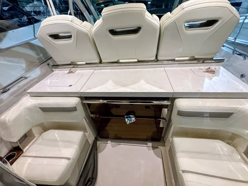 Slide: The Image of Interior of 2024 Tiara Yachts 38 LS with luxurious white seating. - 6