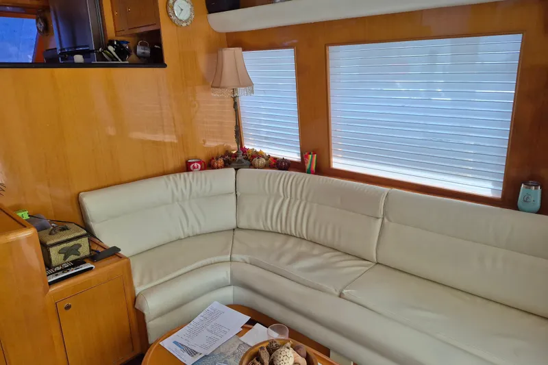 Slide: The Image of Interior of a 2006 Altima Flybridge yacht with a cozy white leather sofa. - 11
