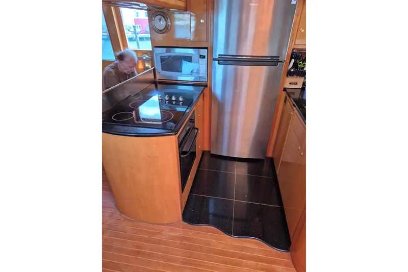 Slide: The Image of Luxurious 2006 Altima Flybridge yacht kitchen with modern appliances and sleek design. - 12