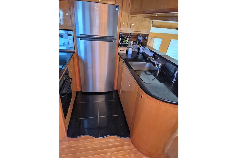 Slide: The Image of Luxurious kitchen interior of 2006 Altima Flybridge yacht with stainless steel appliances. - 13