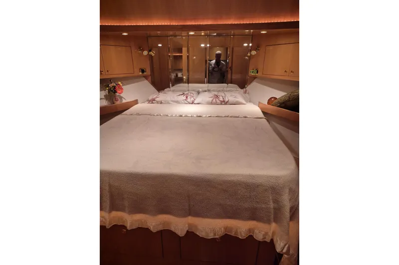Slide: The Image of Luxurious bedroom interior of 2006 Altima Flybridge yacht with elegant bedding and wood cabinetry. - 16