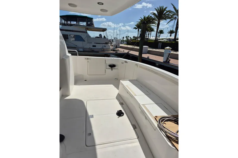 Slide: The Image of 2006 Altima Flybridge boat deck with seating, docked at marina under clear sky. - 8