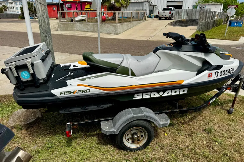 Slide: The Image of 2019 Sea-Doo FishPro 155 on trailer, parked outdoors, featuring fishing equipment. - 3