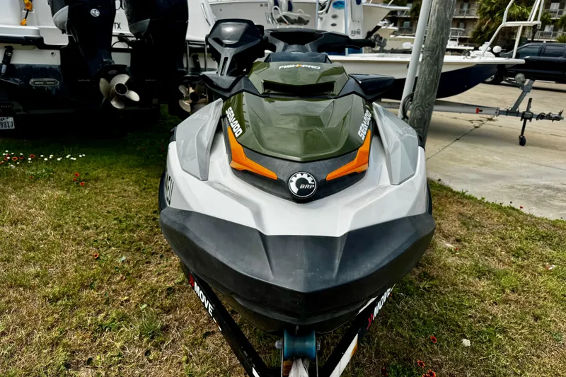 Slide: The Image of 2019 Sea-Doo FishPro 155 jet ski parked on grass near boats. - 4