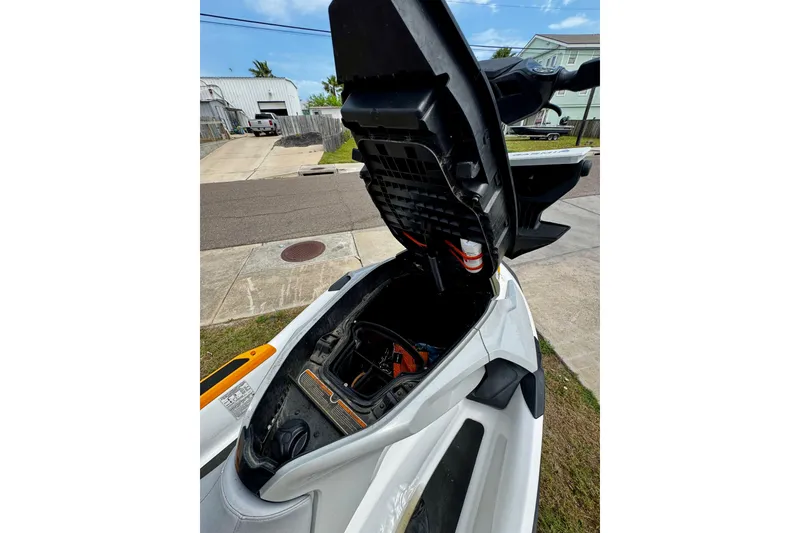 Slide: The Image of 2019 Sea-Doo FishPro 155 with open storage compartment, parked outdoors. - 9