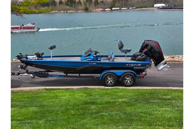 The Image of 2022 Vexus AVX2080 boat on trailer by a lake, showcasing sleek design and powerful engine. - 0