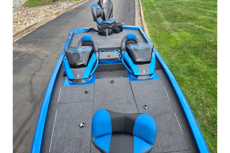 Slide: The Image of 2022 Vexus AVX2080 boat with blue and gray seating on a paved road. - 21
